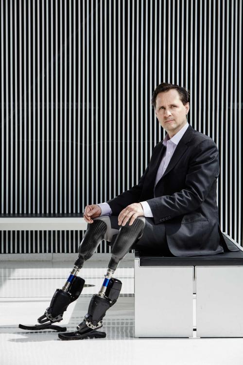 Hugh Herr at MIT Cambridge US with bionical legs sitting