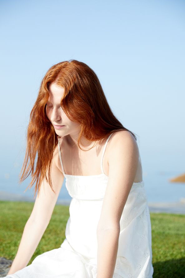 female model, sitting, red hair 