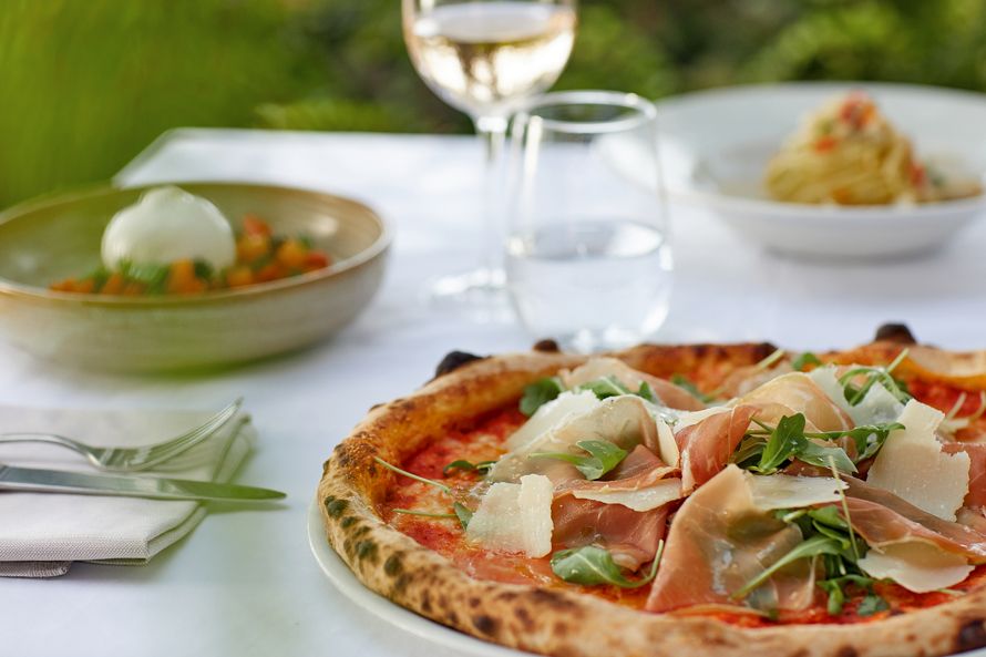 Sani Marina Macaroni, table set with pizza, detail