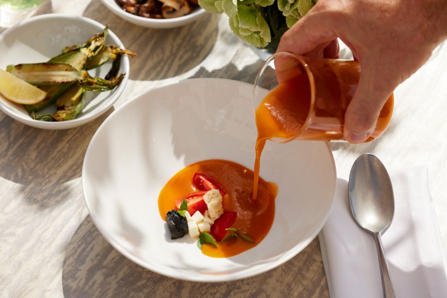 Ikos Oceania, Fresco, Italian Restaurant, chef pours red sauce